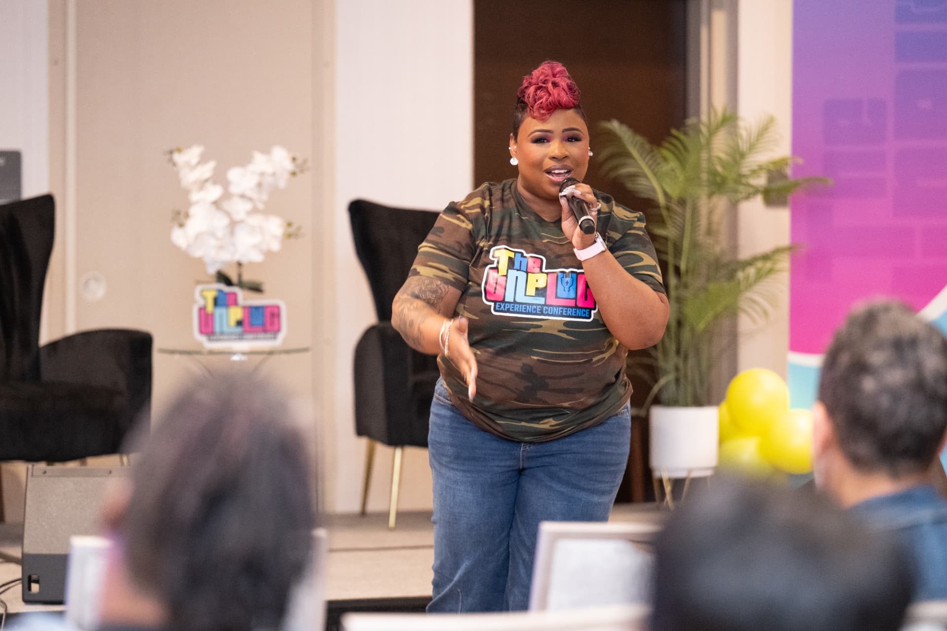 LaShawn speaking on stage with a microphone