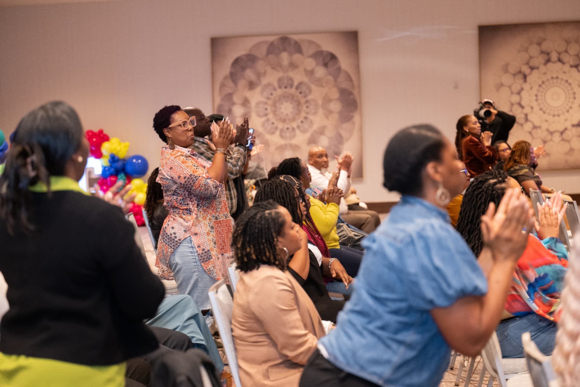 Attendees on their feet celebrating at UNPLUG 2026